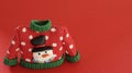 Red Christmas sweater with green collar and sleeve cuffs