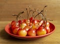 Red sweet cherries on plate on wooden table Royalty Free Stock Photo