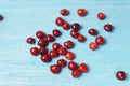 Red sweet cherry scattered on a turquoise wooden table