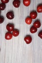 Red sweet cherry scattered on a white wooden table Royalty Free Stock Photo