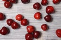 Red sweet cherry scattered on a white wooden table Royalty Free Stock Photo