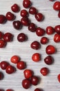 Red sweet cherry scattered on a white wooden table Royalty Free Stock Photo