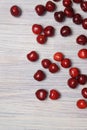 Red sweet cherry scattered on a white wooden table Royalty Free Stock Photo