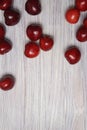 Red sweet cherry scattered on a white wooden table Royalty Free Stock Photo