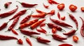 Red sweet peppers whole and half on a white background