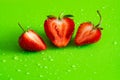 Red sweet ripe strawberry berry on green matte background with water drops Royalty Free Stock Photo