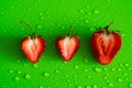 Red sweet ripe strawberry berry on green matte background with water drops Royalty Free Stock Photo