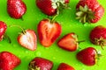 Red sweet ripe strawberry berry on green matte background with water drops Royalty Free Stock Photo