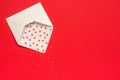 Red Sweets sprinkles candy hearts fly out of white paper envelope on red background. Top view Copy space for text. Concept Royalty Free Stock Photo