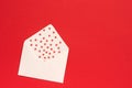 Red Sweets sprinkles candy hearts fly out of white paper envelope on red background. Top view Copy space for text. Concept Royalty Free Stock Photo