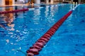 Red Swimming Lane Marker in swimming pool.Color-fast swimming pool lane line.Lane ropes in swimming pool.red plastic