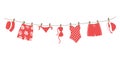 Red swimsuits and swimming trunks hanging on a clothesline. Beautiful swim wear dry on clothespins after swimming