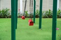 Red swing on children playground in city Royalty Free Stock Photo