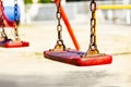 Set of red chain swings on modern kids playground Royalty Free Stock Photo