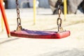 Set of red chain swings on modern kids playground Royalty Free Stock Photo