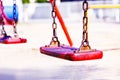 Set of red chain swings on modern kids playground Royalty Free Stock Photo