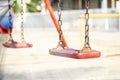 Set of red chain swings on modern kids playground Royalty Free Stock Photo