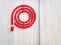 Red Symbol of Fire Hose Reel on Wooden Wall Royalty Free Stock Photo