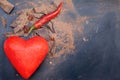 Red symbol of heart and chili peppers and dark chocolate piece Royalty Free Stock Photo