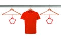 Red t-shirts on hangers and blank tags isolated on white Royalty Free Stock Photo