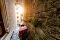 Red table of a street cafe in Kotor between narrow walls