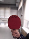 Red table tennis racket, background blur
