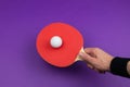 Red table tennis racket in hand. hitting the ball. sport equipment for ping pong Royalty Free Stock Photo