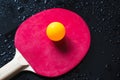 Red table tennis racket with yellow ball Royalty Free Stock Photo