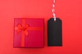 Red tag label and red grift box on black background, blank copy space for you work Royalty Free Stock Photo