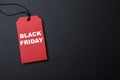 Red tag with words Black Friday on dark background, top view. Space for text Royalty Free Stock Photo