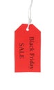 Red tag with words BLACK FRIDAY SALE hanging on background Royalty Free Stock Photo