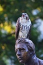 Red-tail hawk screech atop a monument