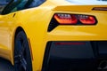 Red tail light on a yellow sporty modern car. Royalty Free Stock Photo