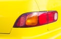 Red taillight on yellow car. Backlight of modern sport car. Four wheels transport. Royalty Free Stock Photo