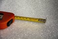 Red tape measure on white foam rubber. Royalty Free Stock Photo