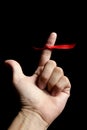 Red tape ribbon, loop tape around human finger