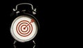 Red target board with arrow inside of alarm clock on black background and copy space , time and business target concept