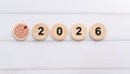 Red Target Bullseye Icon with Wooden Circular Blocks Displaying Year 2026 Royalty Free Stock Photo