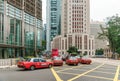 Red taxi cars are stuck in a traffic jam at Central District of Hong Kong city downtown. Taxi services are popular in Hong Kong Royalty Free Stock Photo