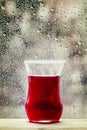 Red tea from China rose in the Islamic glass in the window on a Royalty Free Stock Photo