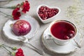 Red tea hibiscus in a vintage cup, antique spoon, cake, raspberry. Copy space