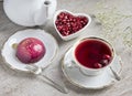 Red tea hibiscus in a vintage cup, antique spoon, cake, raspberry. Copy space