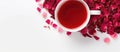 Red tea in a liquid art with rose petals on white table Royalty Free Stock Photo