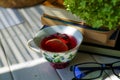 Red tea and reading glasses on the table in a cozy home. Royalty Free Stock Photo