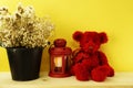 Red teddy bear and clock on yellow background Royalty Free Stock Photo