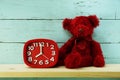 Teddy bear and alarm clock with space copy on wooden background Royalty Free Stock Photo