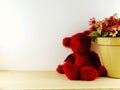 Red teddy bear with tulip artificial flowers bouquet background