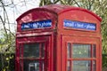 Red telephone booth box for email text and phone retro communication Royalty Free Stock Photo