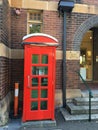 Red telephone booth in street scene