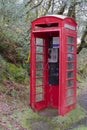 Red telephone box deserted in wilderness countryside rural area